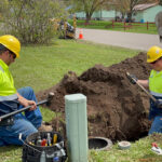 Fiber Construction Technicians Digging to Install a Fiber Pedestal | Mosaic Technolgies
